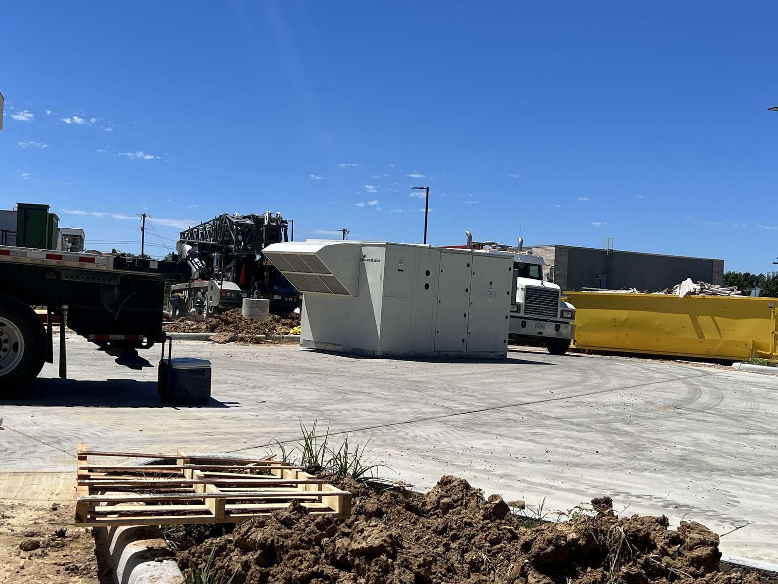 Commercial ClimateMaster unit staged on the ground with the crane truck behind it at Home2 Suites