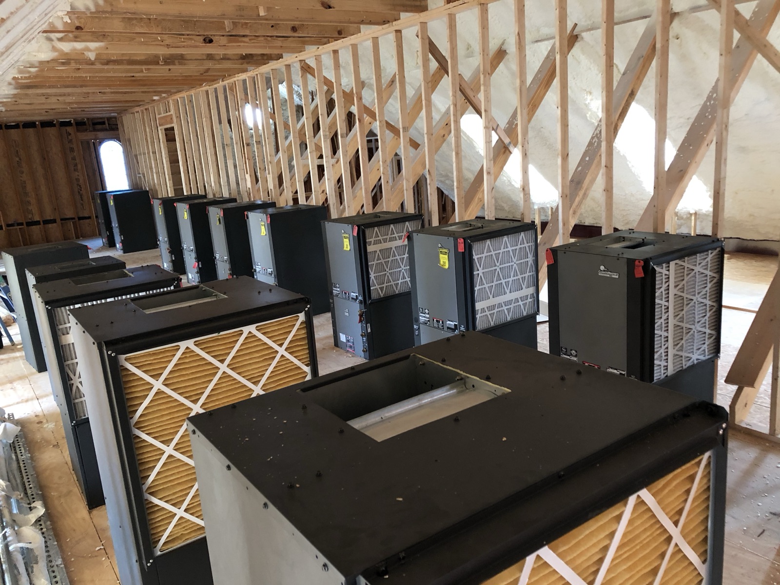 Commercial geothermal heat pump units staged for installation on a DFW project
